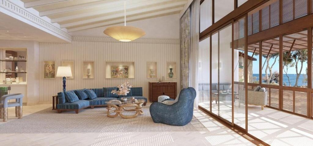 a living room with a blue couch and a table at Mandarin Oriental Punta Negra, Mallorca in Palmanova