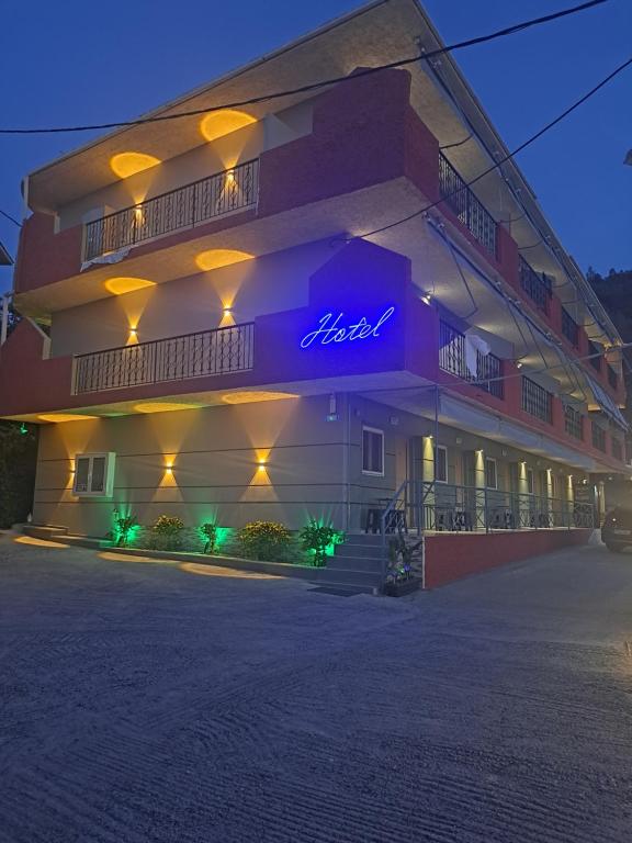 a building with a neon sign on the side of it at Hotel Vasilis Nafplio in Nafplio
