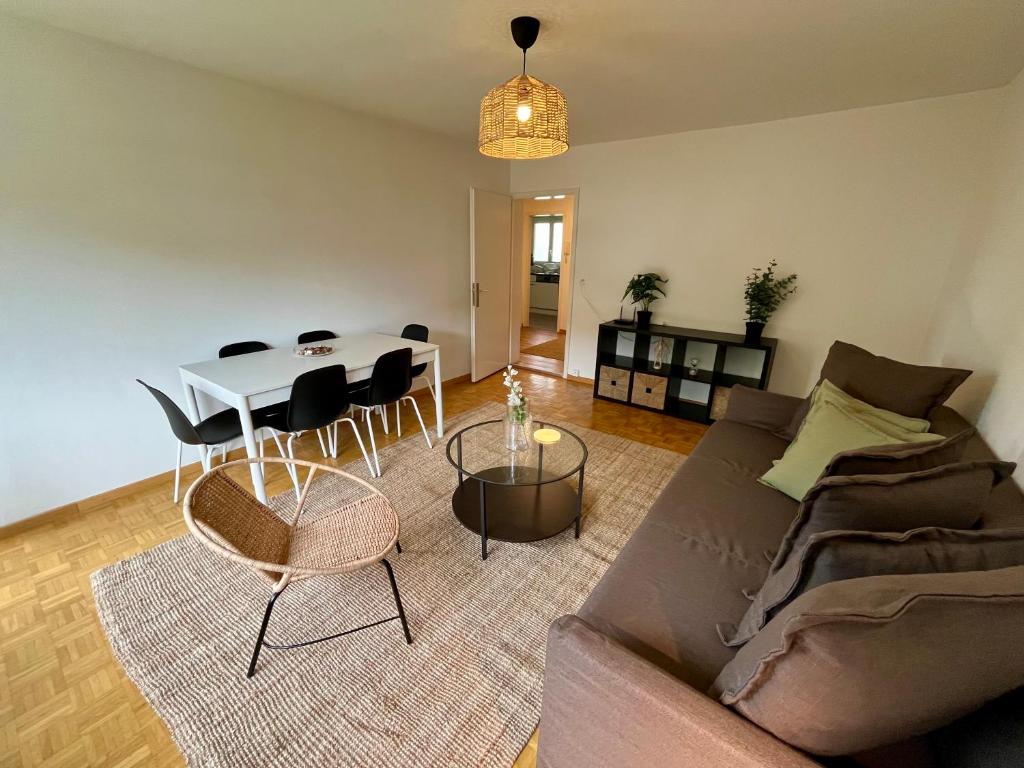 a living room with a couch and a table at Langgrütstrasse 21, 8047 Zürich, Switzerland in Zürich