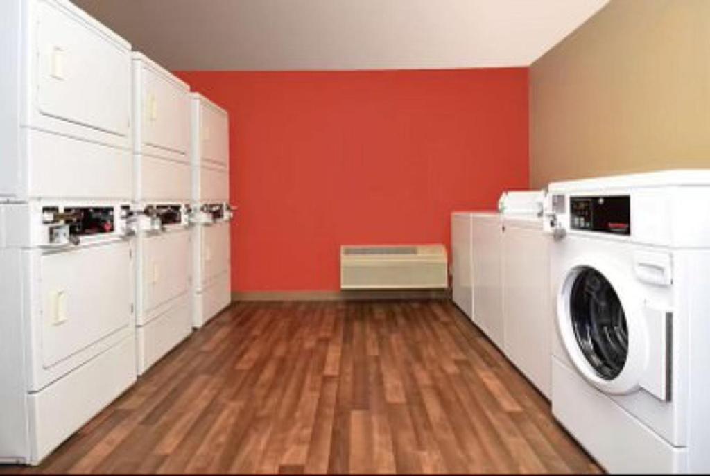a laundry room with a washer and dryer at Candlewood Suites Houston Space Center - Webster in Webster