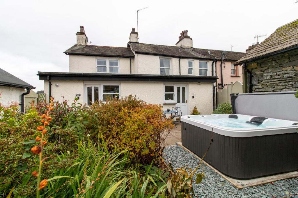 a house with a hot tub in a garden at Wansfell View, Central Hawkshead with Hot Tub in Hawkshead