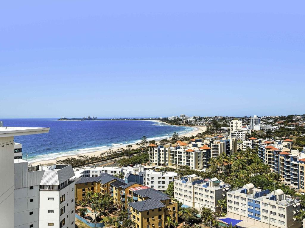 an aerial view of a city and the ocean at The Sebel Maroochydore in Maroochydore