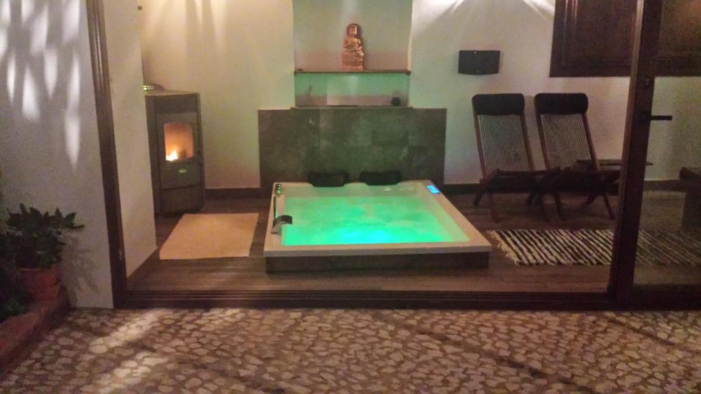 a swimming pool in a room with a fireplace at Casa con encanto el Castaño in Castaño de Robledo