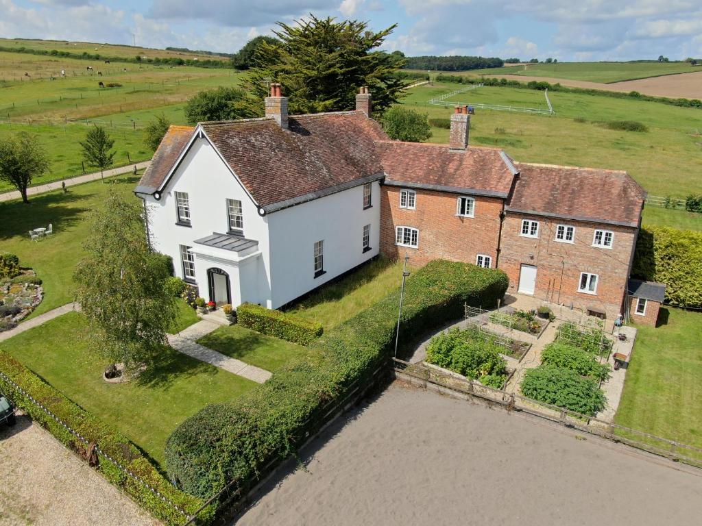 una vista aérea de una casa con un río en Lower Bryanston Farm, en Blandford Forum