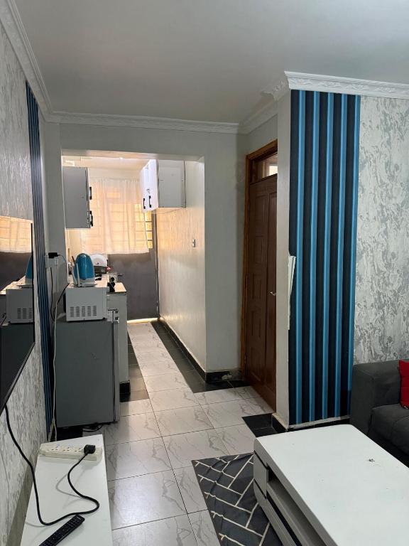 a living room with a couch and a kitchen at 1 Bed in Thika cbd in Thika
