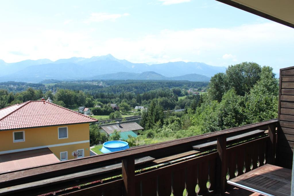 a view of the mountains from the balcony of a house at Appartementhaus Karawankenpromenade in Velden am Wörthersee