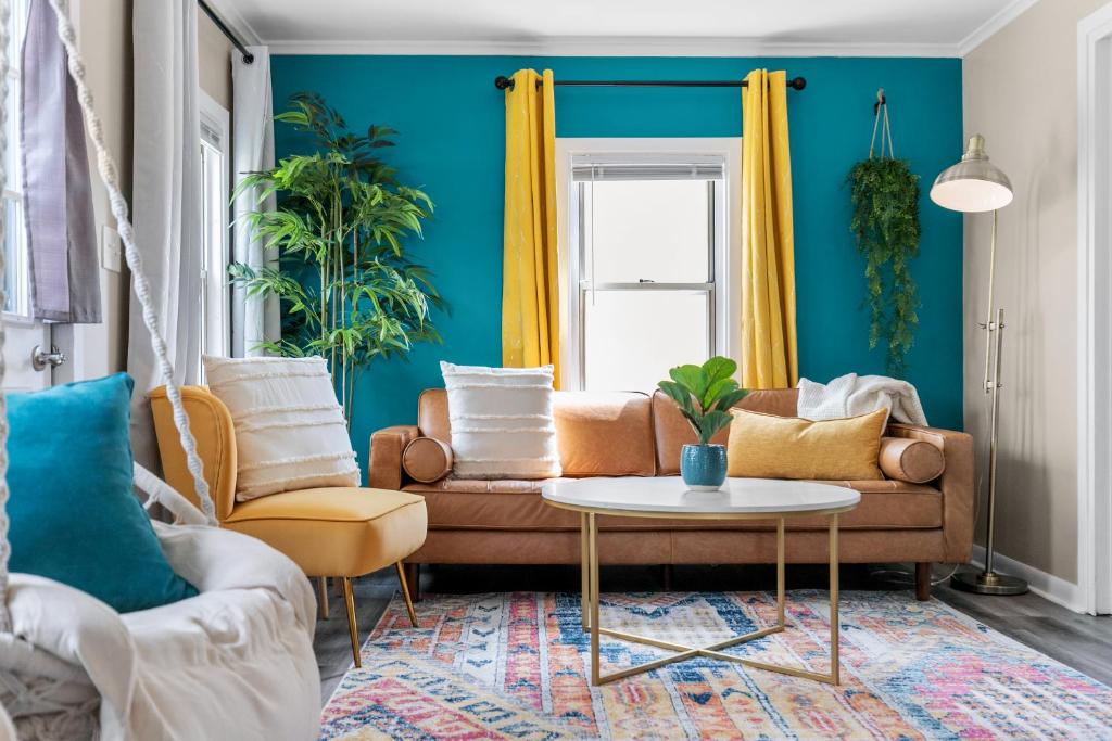 a living room with a couch and a table at Cozy Oshkosh Home Minutes from UW, EAA & Downtown in Oshkosh