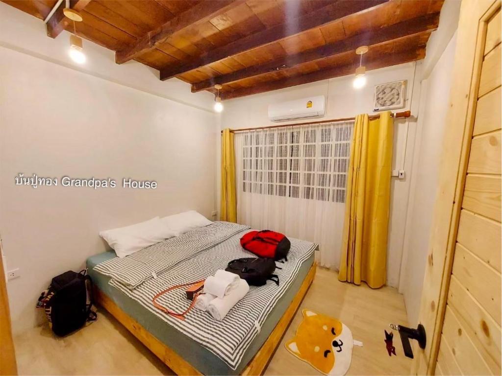 a bedroom with a bed in a room at บ้านปู่ทอง Grandpa's House in Chiang Khan
