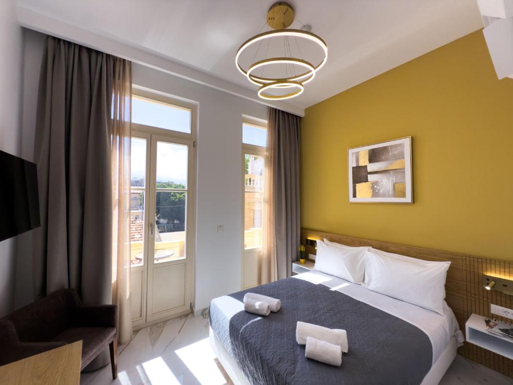 a hotel room with a bed and a window at Deluxe Center Suites in Chania