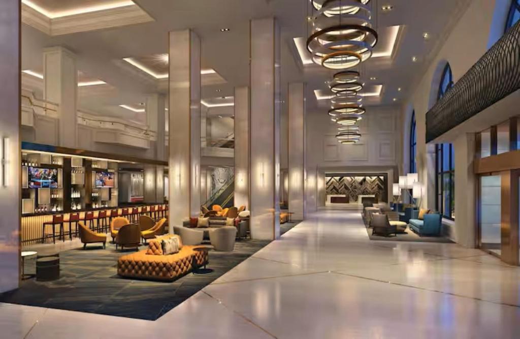 a lobby with couches and chairs and a fireplace at Hilton Minneapolis in Minneapolis