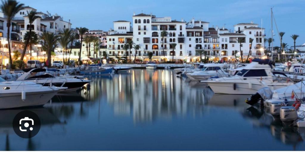 a group of boats docked in a marina with buildings at Acogedora Casa con terraza en Manilva in Manilva