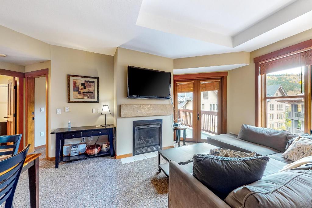 a living room with a couch and a fireplace at Copper One 407 in Frisco
