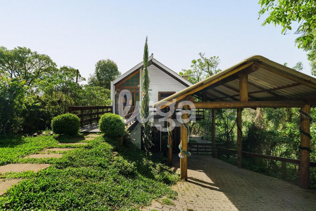 a house with a wooden pavilion in a garden at Suíte Left – Paraíso dos Ciclistas in Gramado