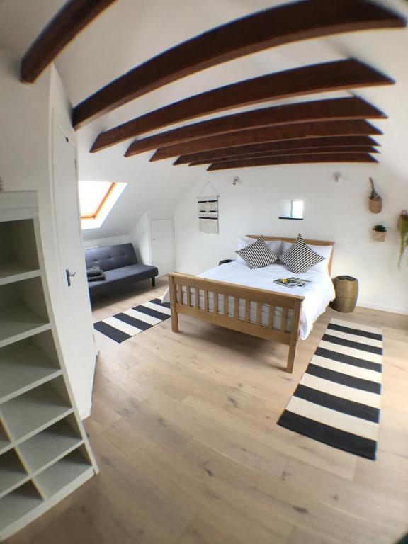 a bedroom with a bed and a couch in a room at The Net Loft in Anstruther