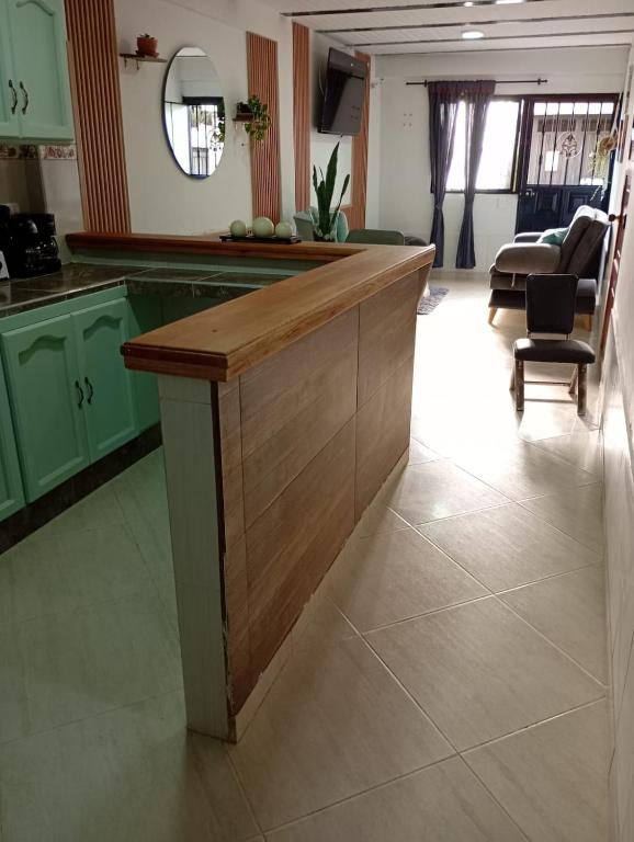 a kitchen with green cabinets and a counter top at Sweet Home in Curití
