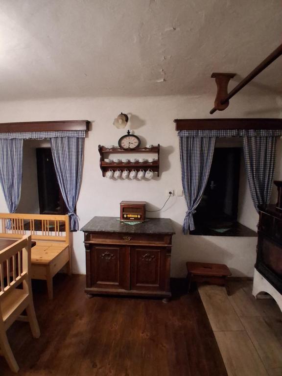 une pièce avec une table en bois et deux fenêtres dans l'établissement Chalupa Vagner, Pernek, à Horní Planá