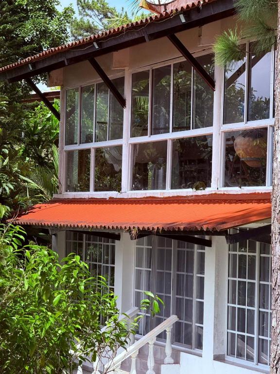 a house with windows and an orange roof at MountainzenEscape in Los Altos de Cerro Azul