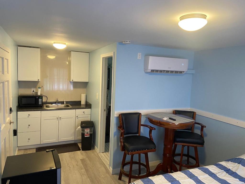 a small kitchen with a table and two chairs at Cozy Studio in Quiet Neighborhood in Bradenton
