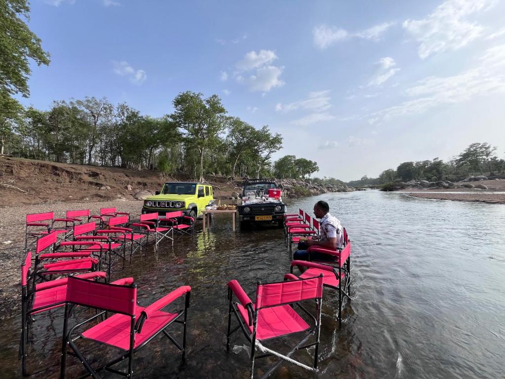a group of chairs in the water on a boat at HOME in the JUNGLE in Seonī
