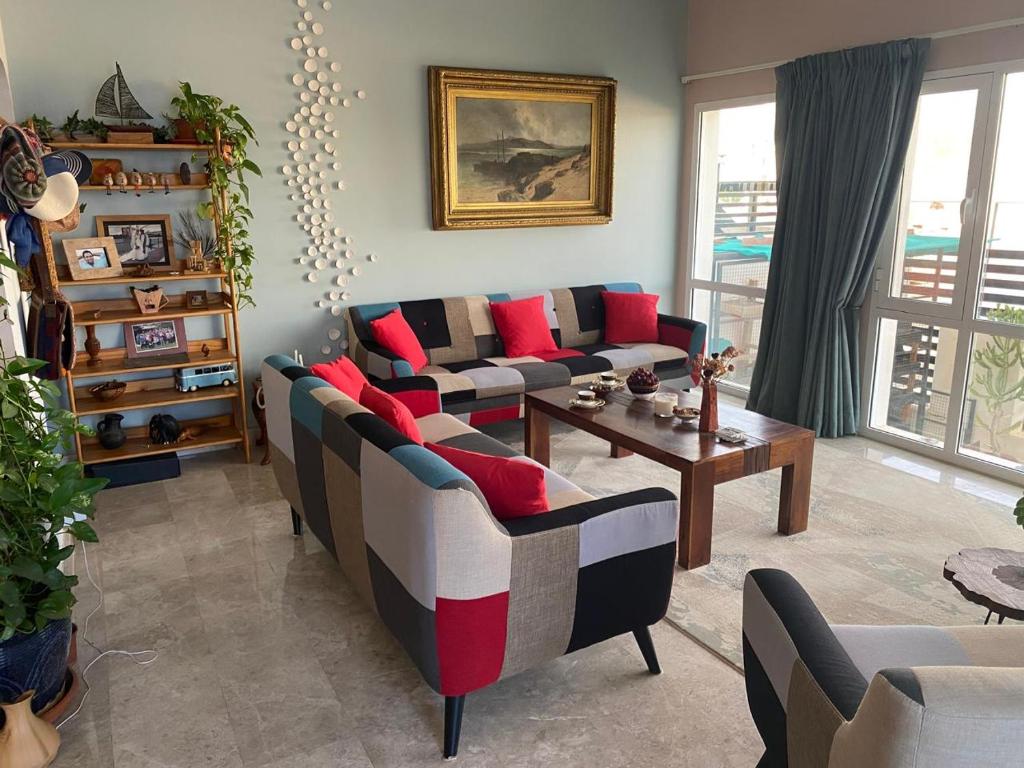 a living room with couches and a table at Sunset Views in Muscat