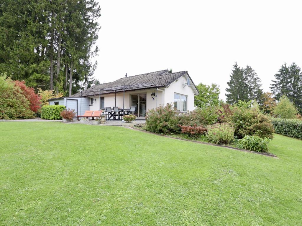 a white house with a lawn in front of it at Coeur de Biche in Rendeux