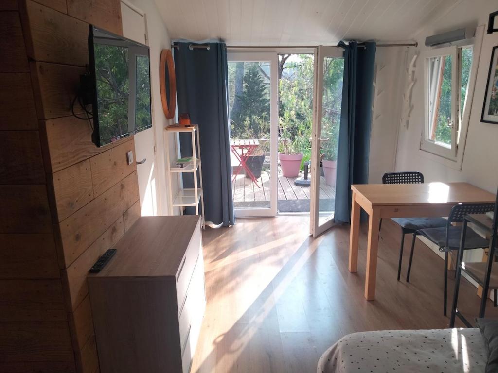 a living room with a table and a dining room at Chalet Nanou in La Ciotat