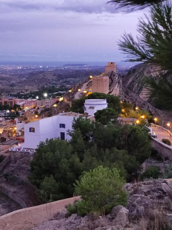 a view of a city from a hill at night at La Torre Blai in Jijona