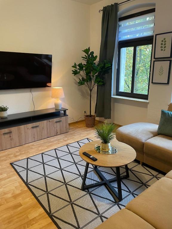 a living room with a couch and a coffee table at Moderne Wohnung für 4 Personen in Zeitz