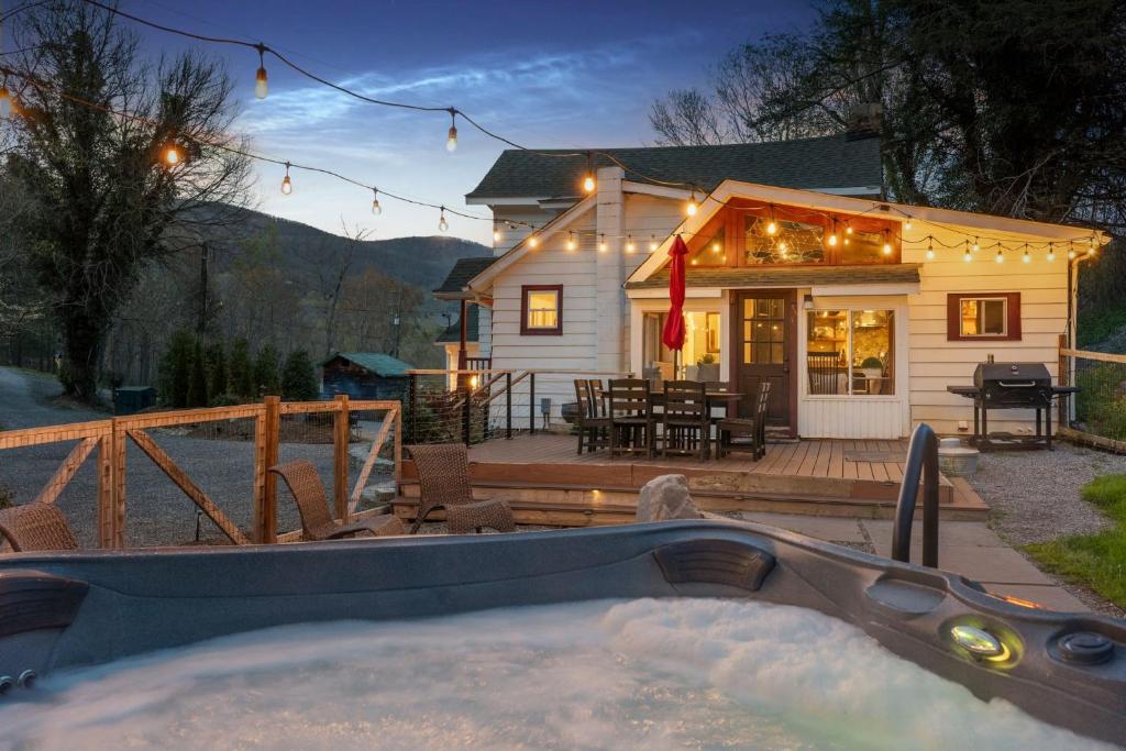a house with a hot tub in front of it at 1910 Asheville Gem in Fairview