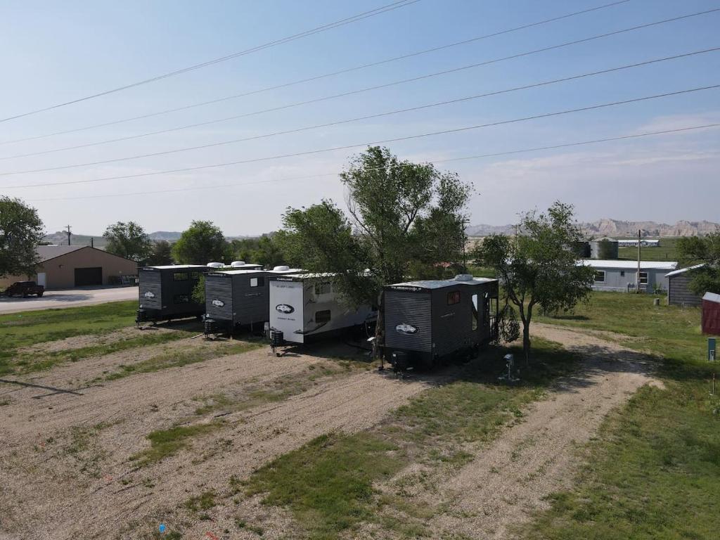 a group of trailers parked in a field at Grasshopper Flats RV Pad in Interior