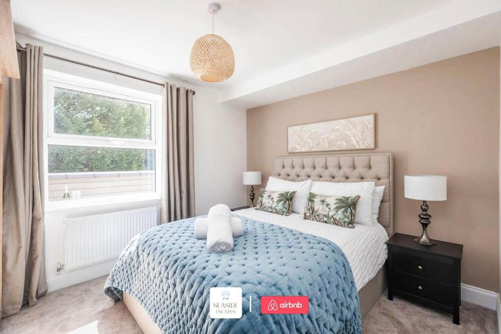 a bedroom with a bed with a teddy bear on it at Beachside Retreat l Sun Terrace l Hot Tub l Free Parking l Seaside Escapes Short Lets & Serviced Accommodation in Bournemouth