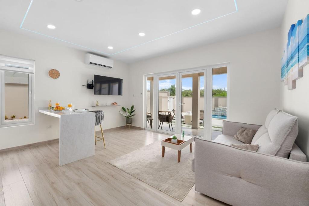 a living room with a couch and a table at Dreamy Getaway w/ Private Pool | BBQ |5min Airport in Tanki Lender