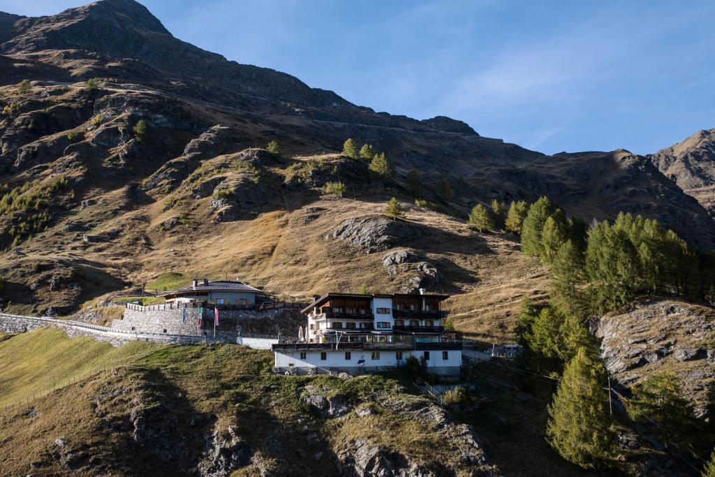 a house on the side of a mountain at Hochfirst in Corvara in Passiria