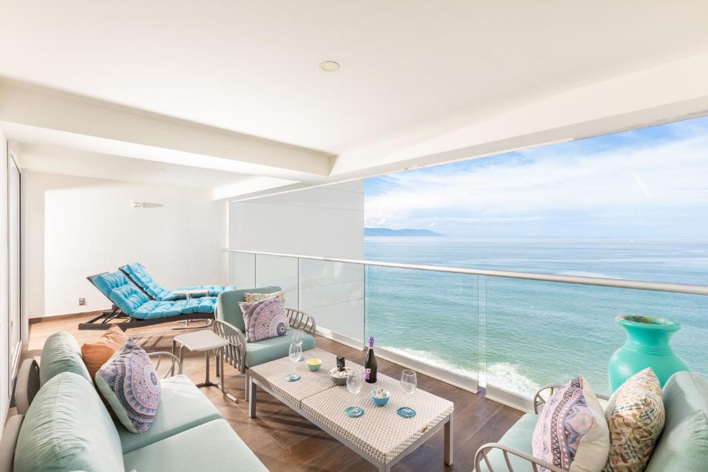 a living room with a view of the ocean at Luxury 2-Bedroom Beachfront Oasis – Two Balconies to Soak in the Views in Puerto Vallarta