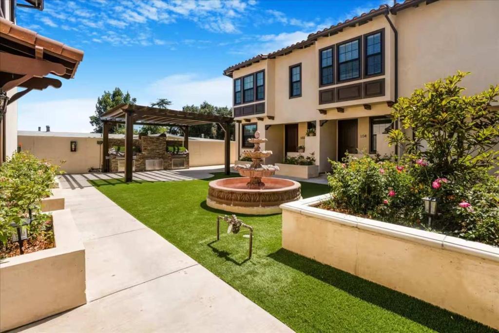 a backyard with a fountain and grass at Newly Built Pasadena Retreat Parking Great Location in East Pasadena