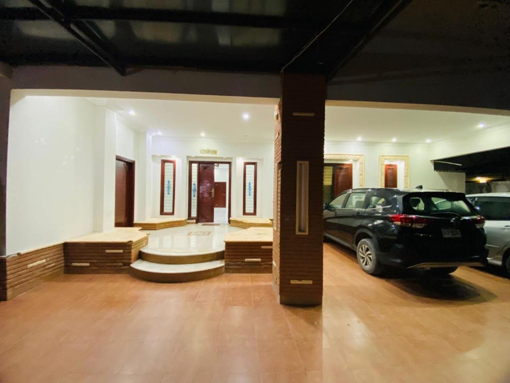 a garage with a car parked in a parking lot at Seaview Luxury Hotel in Karachi