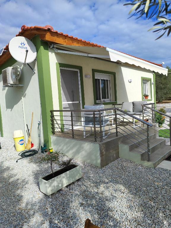 a small house with a porch and stairs to it at Ismini's Luxury Villas in Mirodháton