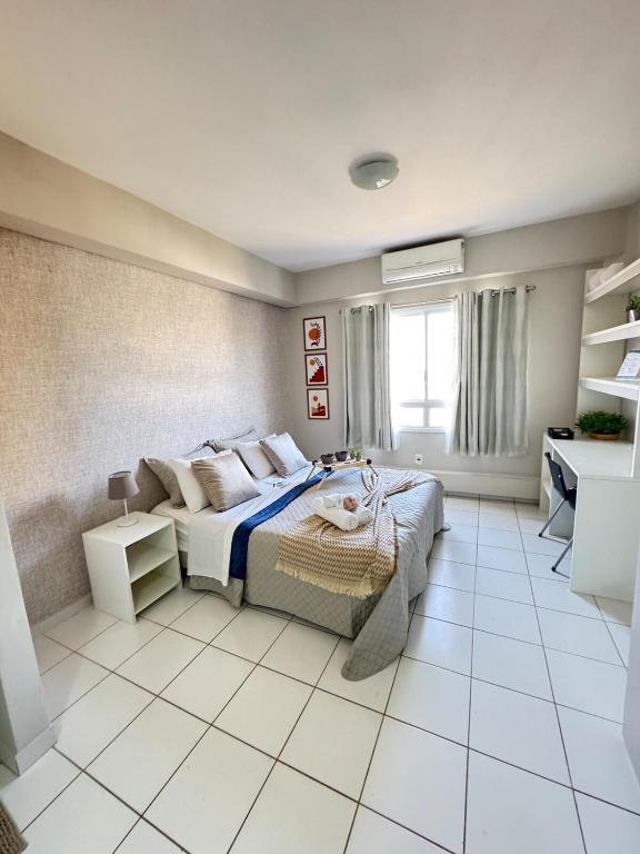 a bedroom with a bed and a desk in it at Travellar Spot 1317A in Ribeirão Preto