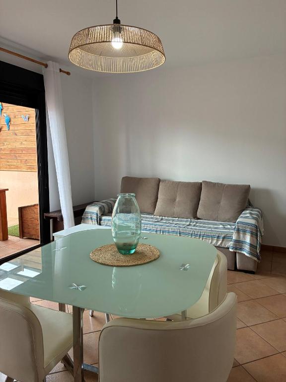 a blue table with chairs and a glass vase on it at Vivienda Vacacional Nura in Lajares