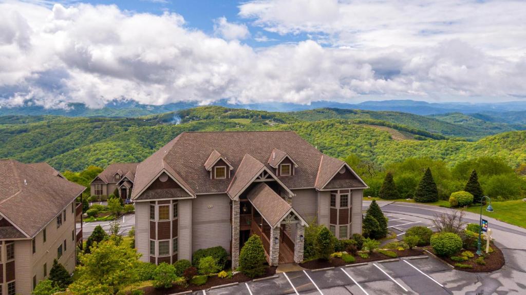 an aerial view of a house with mountains in the background at SugarJax at The Reserve in Banner Elk