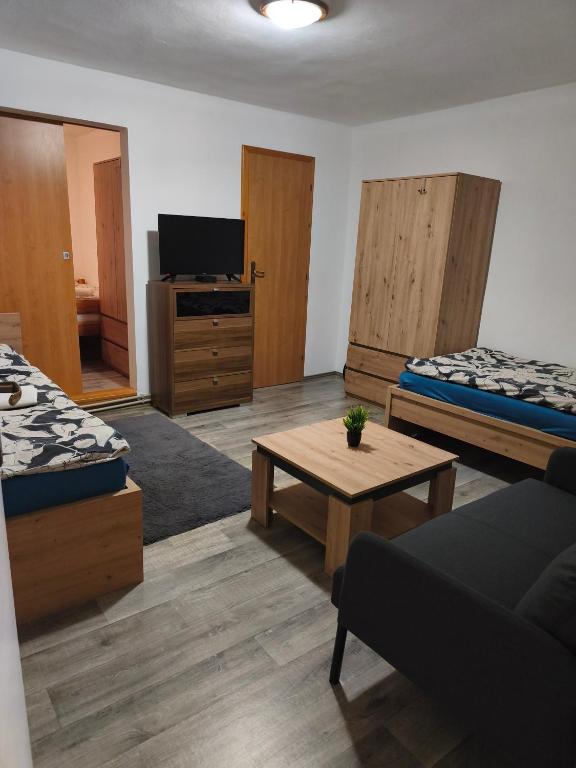 a living room with two beds and a coffee table at Ubytovanie Hrabiny in Sučany