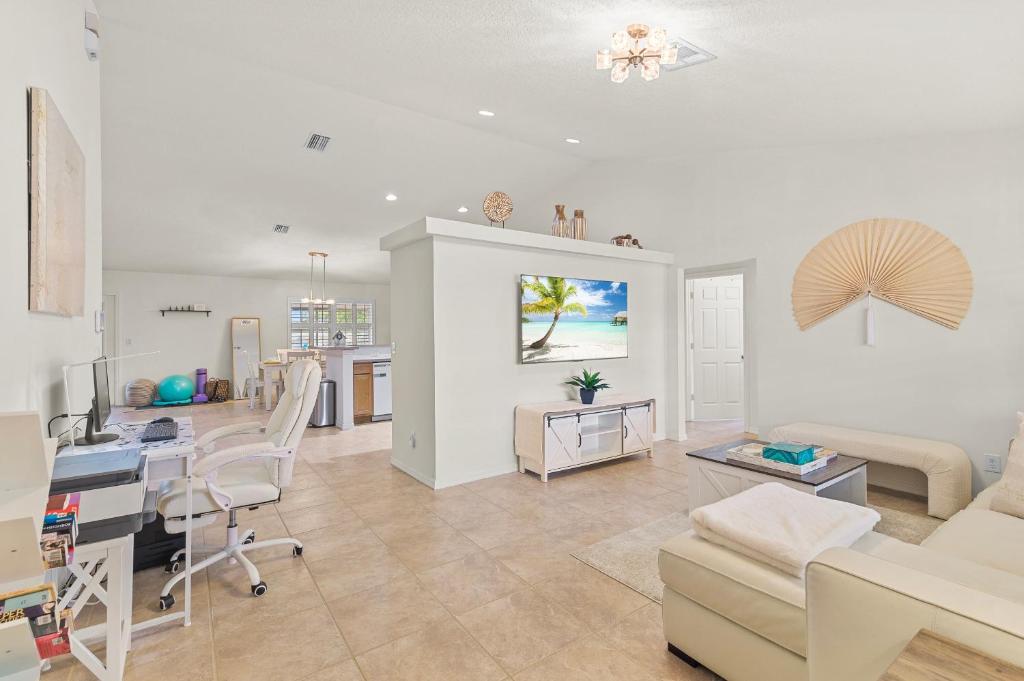 a living room with a kitchen and a dining room at Life is Good! in Port Saint Lucie