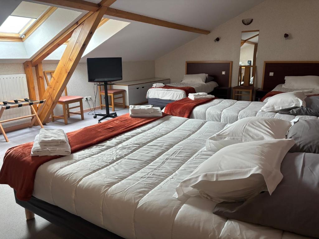 a room with four beds in a attic at Les Hirondelles in Orcines