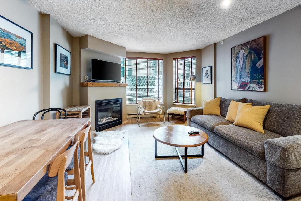 a living room with a couch and a table at The Marquise 321 in Whistler