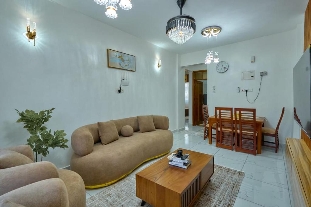 a living room with a couch and a coffee table at Royal Suites in Mombasa