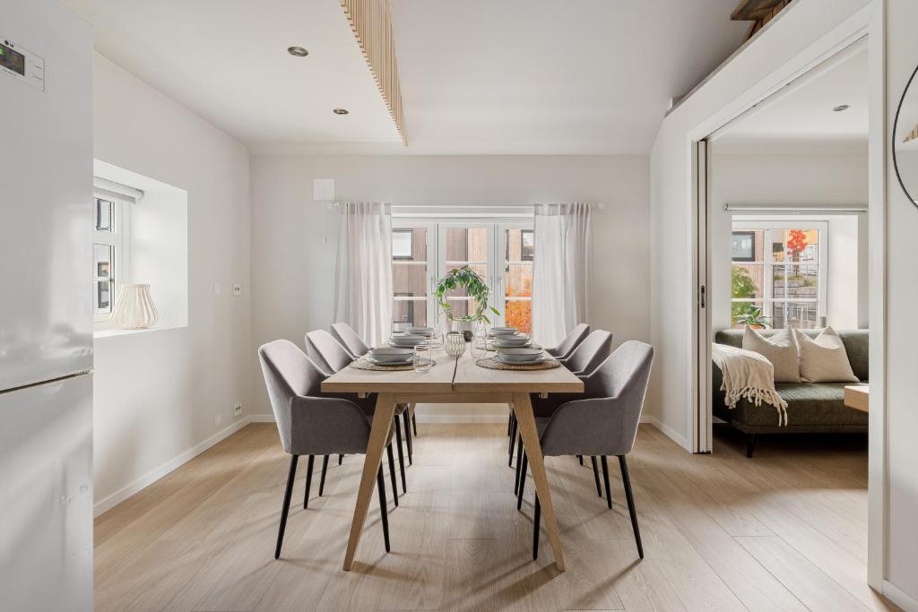 a dining room with a table and chairs at Central loft apartment, with a view from the roof terrace in Tromsø