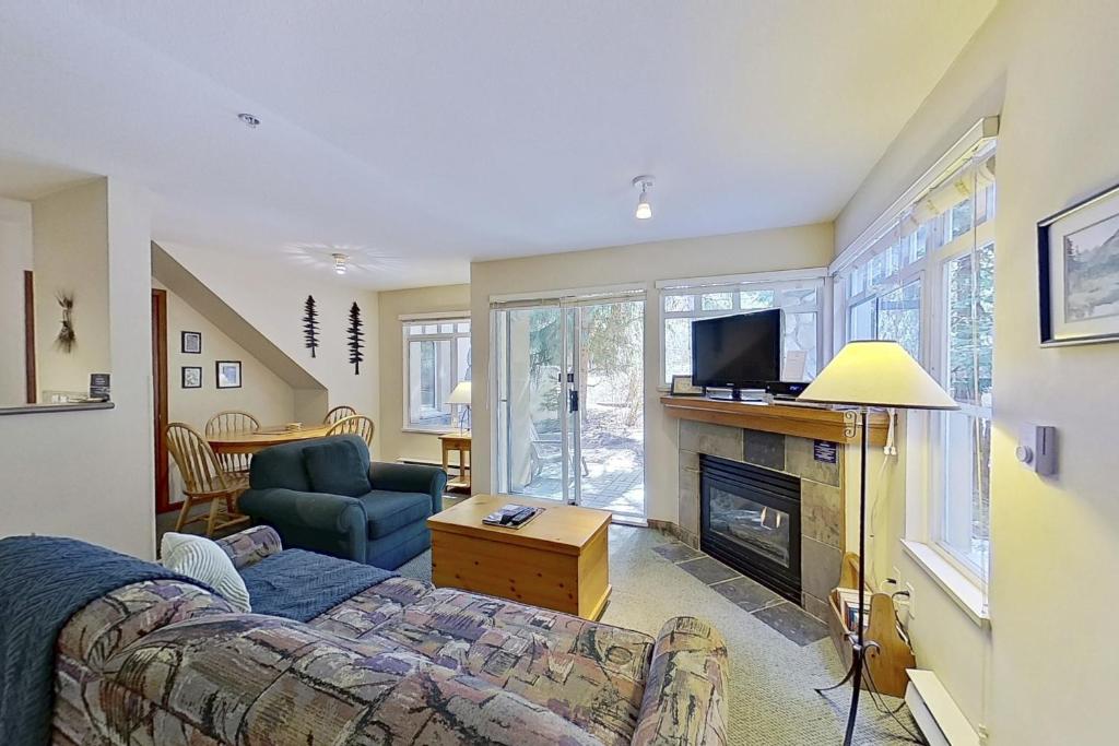 a living room with a bed and a fireplace at The Lagoons 27 in Whistler