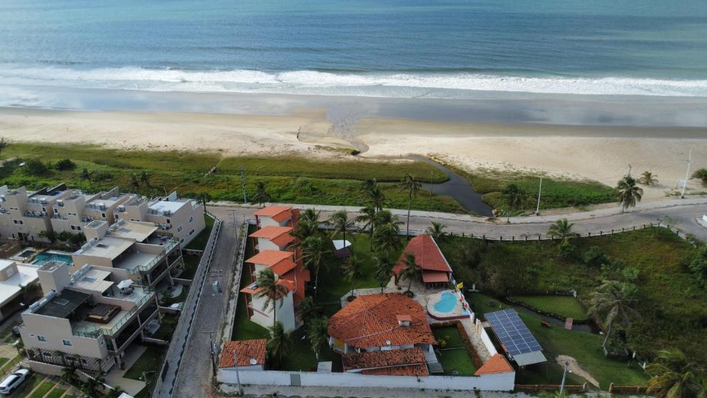 an aerial view of a beach with houses and the ocean at Pousada Red House in Flecheiras