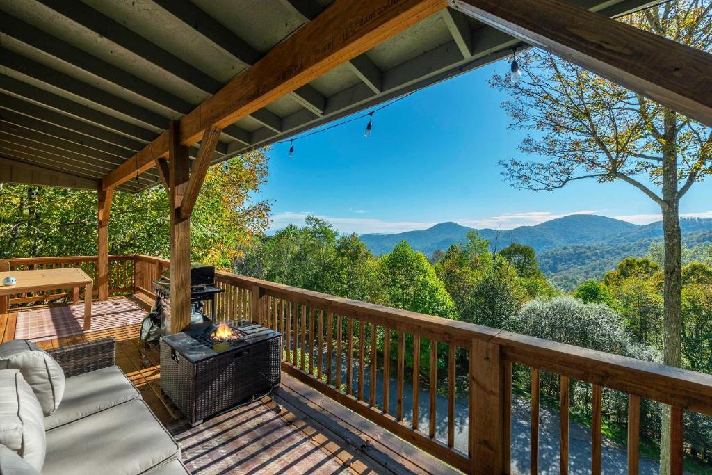 a deck with a fireplace and a view of the mountains at Mountain Views Hot Tub Family Room & Game Room in Swiss