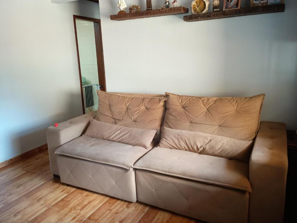 a brown couch sitting in a living room at House available for the Rock the Mountain event in Petrópolis